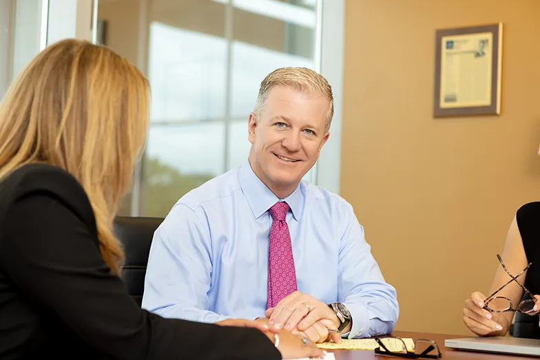 Michael A. Weinberg and Dawn Kaplan at a conference table in a bright office.